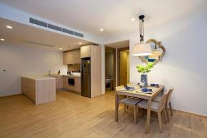 a kitchen and dining room with a table and chairs at Baan Mai Khao Condo Phuket for rent in Phuket