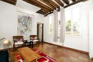 a living room with a table and a large window at My Trip in Paris - Argout in Paris