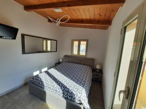 a bedroom with a bed and a tv on the wall at I 4 Leoni in Conversano