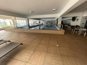 a large indoor swimming pool in a building at Flat Veredas 305 com ar condicionado sala - 300 metros do Hot Park in Rio Quente