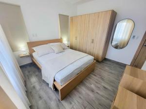 a bedroom with a large bed and a mirror at Lovely Condo in Gated Community in Sosúa +6 photos