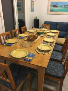 a wooden table with plates on top of it at House of Blue at Turtle Cove Long Island Bahamas in Long Island