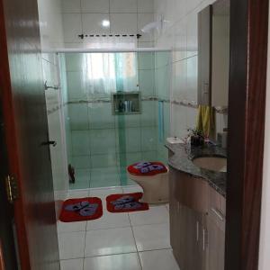 a bathroom with a shower and a toilet and a sink at Queiroz e Melânia in Penha +4 photos