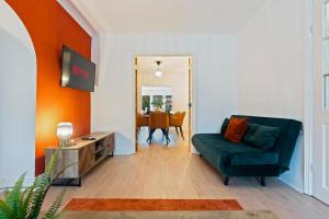 a living room with a couch and a table at Stylish 3 Bedroom Contractor Stay House in Birmingham B23 near M6 & Fort Dunlop with Free Parking and WiFi in Birmingham