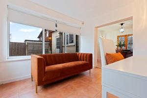 a living room with a couch and a large window at Stylish 3 Bedroom Contractor Stay House in Birmingham B23 near M6 & Fort Dunlop with Free Parking and WiFi in Birmingham