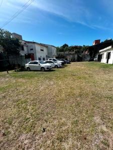 a group of cars parked in a yard at Hotel New SAN MARCOS in Mar de Ajó +13 photos