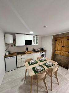 a kitchen with a table and chairs in a room at Casa do Castelo in Trancoso