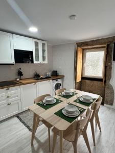 a kitchen with a table and chairs in a kitchen at Casa do Castelo in Trancoso +11 photos