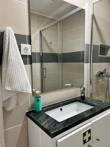 a bathroom with a sink and a shower at Casa do Castelo in Trancoso +11 photos