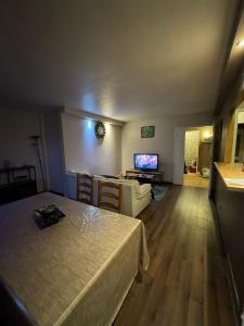 a bedroom with a bed and a living room at Great apartment quiet neighborhood in Élancourt