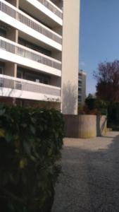 a white building with a tree in front of it at Great apartment quiet neighborhood in Élancourt
