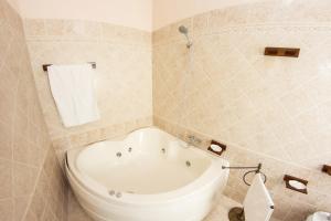 a bathroom with a bath tub and a towel at Casa Vacanze Vista Mare in Castel di Tusa +16 photos
