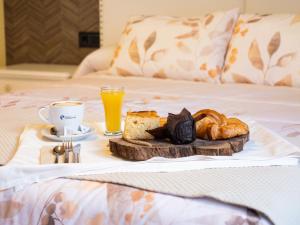 a breakfast tray with bread and coffee on a bed at Apartamento Los Castillos 1I in Tordesillas +2 photos
