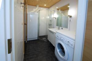 a bathroom with a washing machine and a sink at Levi Chalets 1202 in Levi +11 photos