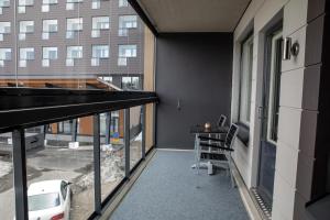 a balcony with a table and chairs in a building at Levi Chalets 1202 in Levi