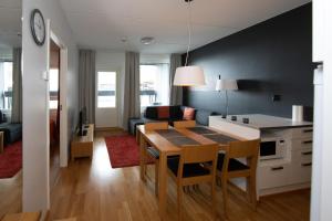 a kitchen and living room with a table and chairs at Levi Chalets 1202 in Levi