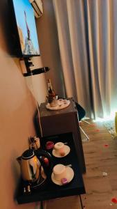 a table with a tea set and cups on it at The greenary guest house and restaurant in Thohoyandou