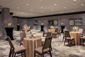 a banquet room with tables and chairs with flowers on them at The Westin Southfield Detroit in Southfield