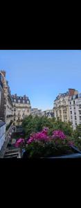 a view of a city with pink flowers and buildings at Cosy private room in Shared appartment - 1 person only ! in Paris