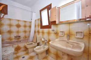 a bathroom with a sink and a toilet at KarolinaHouse in Ágios Matthaíos +3 photos