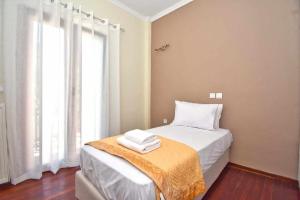 a bedroom with a bed and a window at KarolinaHouse in Ágios Matthaíos