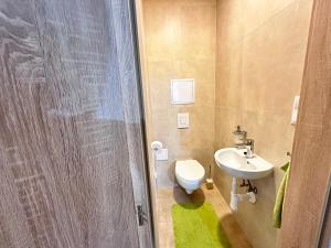 a small bathroom with a toilet and a sink at Apartmán Orech in Belá +11 photos