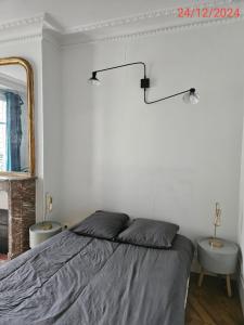 a white bedroom with a bed and a mirror at Cosy private room in Shared appartment - 1 person only ! in Paris