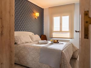 a bedroom with a bed with a tray of food on it at Apartamento Los Castillos 2D in Tordesillas