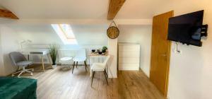 a living room with a table and a dining room at Apartment in Weißenfels bei Leuna mit WLAN & Terrasse in Weißenfels