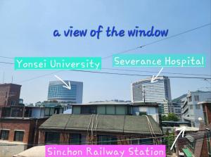a view of the window and a view of a city at Shinchon Stay in Seoul
