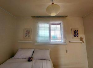 a bedroom with a bed and a window at Shinchon Stay in Seoul