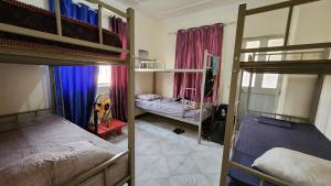 A bed or beds in a room at MEETING POINT HOSTEL-Praia Group Reservations