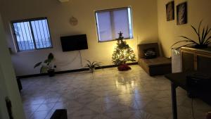 A television and/or entertainment centre at MEETING POINT HOSTEL-Praia Group Reservations