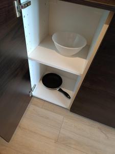 a white cabinet with a bowl and a sink at Good Night in Szczecin in Szczecin