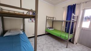 A bed or beds in a room at MEETING POINT HOSTEL-Praia Group Reservations