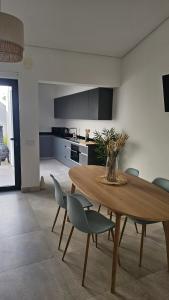 a kitchen and dining room with a wooden table and chairs at City Center Villa in Faro +24 photos