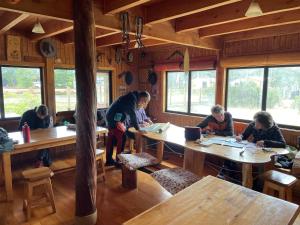 a group of people sitting at tables in a restaurant at El Mosco in Villa O'Higgins