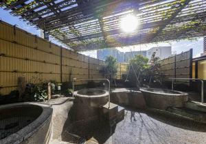 a bathroom with two tubs in a building at APA Hotel Kanazawa Ekimae in Kanazawa