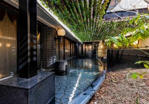 a swimming pool in the courtyard of a house at APA Hotel Kanazawa Ekimae in Kanazawa
