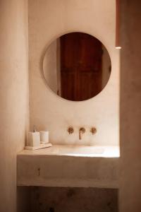 a bathroom with a sink and a mirror at Posada Rebaños in San Rafael