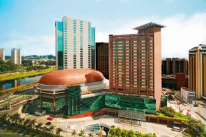 a large building with a dome in a city at Sheraton São Paulo WTC Hotel in Sao Paulo