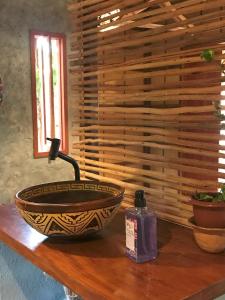 a bowl on a table with a bottle of soap at Chalé Dona Ramira in Alter do Chao