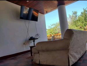 a living room with a couch and a flat screen tv at Los tisseaux in Casares