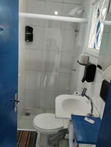 a small bathroom with a toilet and a sink at Pousada Cantinho da Mi & Teco in Campos do Jordão +35 photos