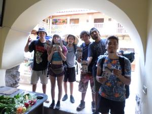 a group of people posing for a picture under an arch at OkiDoki Cusco Hostal in Cusco