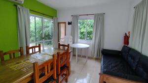 a dining room with a table and chairs and green walls at Cabañas OliBer in Potrero de los Funes +27 photos