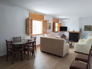 a living room with a couch and a table and chairs at Casa Montilla in Granada