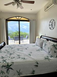 a bedroom with a bed with a view of a balcony at Seaside Serenity 2b2b With Panoramic Terrace in Coco