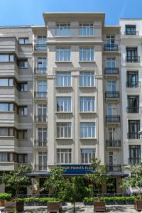a large building with a sign in front of it at Four Points Flex by Sheraton Istanbul Taksim Square in Istanbul