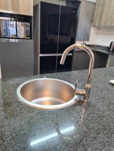 a stainless steel sink in a kitchen counter at Lerewa in Gaborone